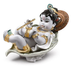 Figurka Krishna na liściu